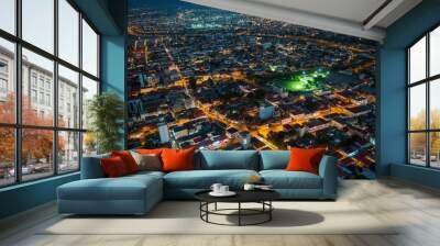 Aerial view of Accra cityscape at night. Modern architecture, old buildings, bridge, railway, roads, streets. People walking, city life, urban landscape. Central business district, city center, Wall mural