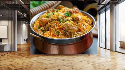 Close-up of Chicken biryani in a pot on table. Traditional Indian dish with basmati rice, marinated chicken, herbs, and spices. Fresh ingredients and natural flavors combine for a delicious meal. Wall mural