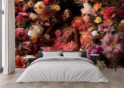 Stunning black woman lies amidst vibrant flowers in a pink dress. Afro-styled hair and elegant pose exude high-end fashion. Conceptual perfume photo showcases femininity and fertility. Wall mural