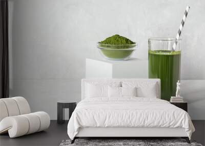 Green drink with chlorella in a glass and powder on a white concrete background. Healthy detox drink. Superfood concept. Copy space. Wall mural