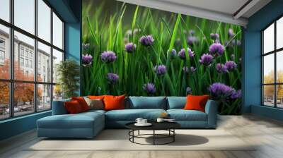 Vibrant purple flowers bloom amidst lush green grass, creating a serene and picturesque natural landscape. Wall mural