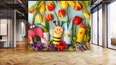 Happy easter spring toy collection and fresh flowers on blue background, kids holiday party concept background. Paper crafts, DIY. creative idea from toilet roll. reuse, recycle Wall mural