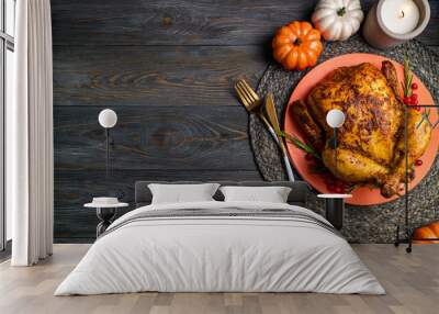 Baked chicken for Thanksgiving Day. Roasted whole chicken or turkey with herb rosemary and berries for thanksgiving dinner on wooden table. Festive table settings for Thanksgiving Day. Copy space Wall mural