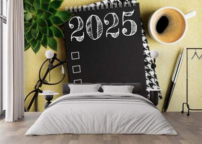 New year resolutions 2025 on desk. 2025 resolutions list with notebook, coffee cup on table. Goals, resolutions, plan, action, checklist concept. New Year 2025 template, copy space Wall mural