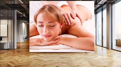 Beautiful young woman getting spa massage Wall mural