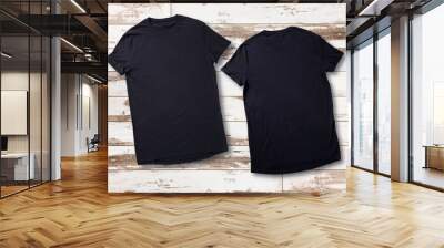 Mockup of blank black tshirt front and rear on white wooden background. Shirt design for man. Flat lay, top view. Wall mural