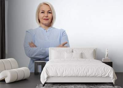 Serious business woman with folded arms on white background Wall mural