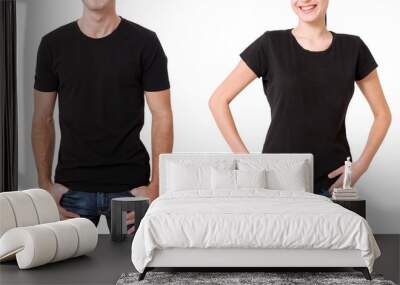 Shirt design and people concept - close up of young man and woman in blank black t-shirt front isolated. Wall mural