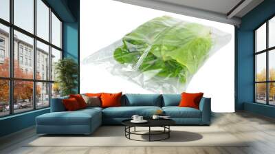 A sealed plastic bag of lettuce on a white background Wall mural