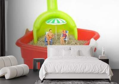 miniature holiday makers relaxing in a bucket of sand Wall mural