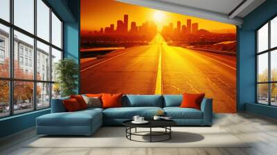 City skyline at sunset with golden road leading in, bright sun and silhouette of buildings Wall mural