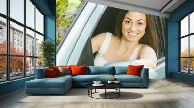 Happy young woman driving a car Wall mural