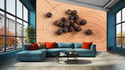 Peppercorns in warm light on wood close-up Wall mural