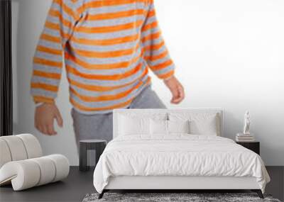 handsome young boy stands with foot on football, on white backgr Wall mural