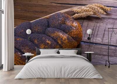 Assortment of baked bread on wooden table background Wall mural