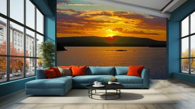 Bright colorful sunset over a lake. Beautiful reflection by a tranquil water of amazing sky and the lakeside at sundown in the summer evening. Lake Elovoe (Spruce Lake), South Ural, Russia. Wall mural