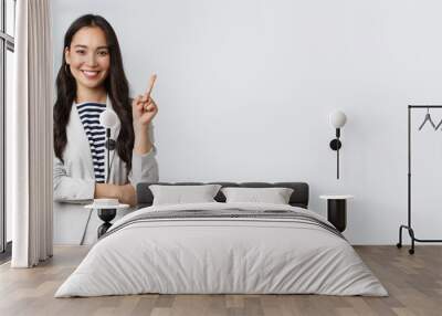 Business, finance and employment, female successful entrepreneurs concept. Successful female businesswoman, asian real estate broker pointing finger, showing number one and smiling Wall mural