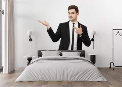 Business Concept: Attractive handsome business man shows hand on side. Copy space on white background Wall mural