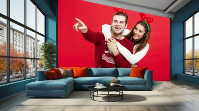 Christmas Concept - portrait lovely young couple finger on side well use for presentation or montage Wall mural