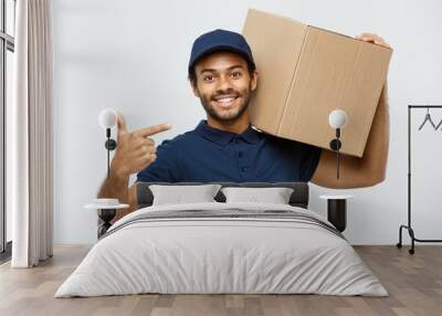 Delivery Concept - Portrait of Happy African American delivery man pointing hand to present a box package. Isolated on Grey studio Background. Copy Space. Wall mural