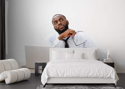 thoughtful young african american businessman working on laptop computer Wall mural