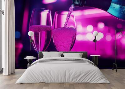 Two glasses of pink champagne are poured into each other. Concept of celebration and romance Wall mural