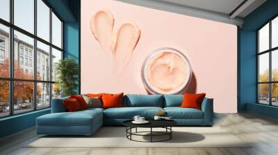 Open jar of beauty cream and swatch on pink peach background Wall mural