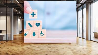 Businessman chooses a emoticon icons healthcare medical symbol on wooden block , Healthcare and medical Insurance concept Wall mural