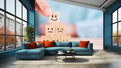 Businessman chooses a smiley face happy symbol on wooden block , Services and Customer satisfaction survey concept Wall mural