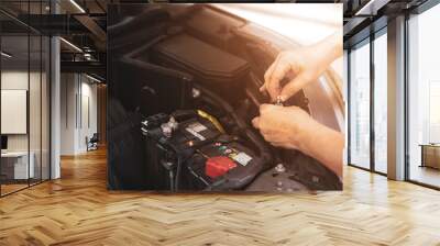 Hands of car mechanic working with checking car engine in auto repair service center Wall mural