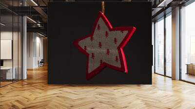 Red glitter star shaped christmas decoration isolated on black background Wall mural