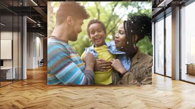  Portrait of cheerful African American parents with daughter in park. Wall mural