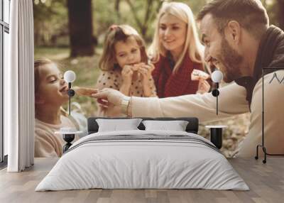 Family having picnic in park. Wall mural