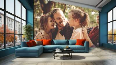 Happy family in park having conversation and hugging. Wall mural