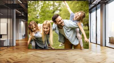 Happy parents with daughter at park. Wall mural