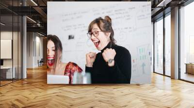 Candid moment, portrait of happy businesswoman celebrating the success of group project in the office, looking at laptop screen. Teamwork  success concepts. Wall mural