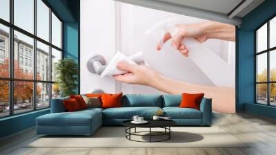 cleaning white door handles with an antiseptic wet wipe and sanitizer spray. disinfection in hospita Wall mural