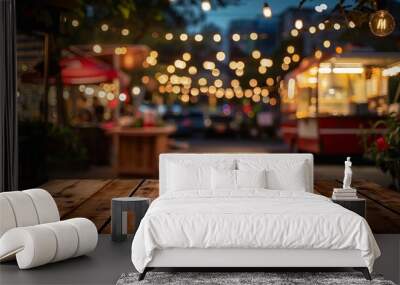 Empty wooden tables on blurred food truck festival and vivid bokeh lights as a background. Wall mural