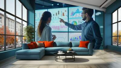 Analysts working with interactive dashboards displaying real-time data, charts, and graphs. Emphasize the role of big data and AI in driving business insights and decision-making.  Wall mural