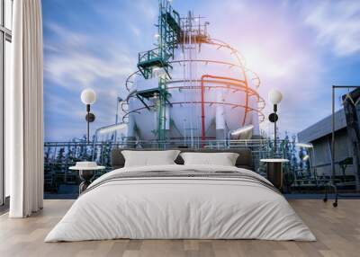 Gas storage spheres tank in oil refinery plant on sky sunrise Wall mural