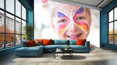 Portrait of blonde girl smiling with painted face Wall mural