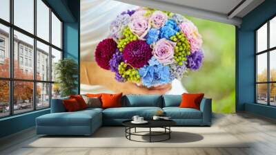 bride holding bouquet of flowers Wall mural