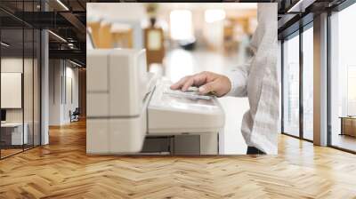 A man using a copier in the office. Wall mural