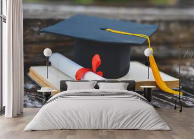 Black graduates hat and yellow tassel place an old book Wall mural