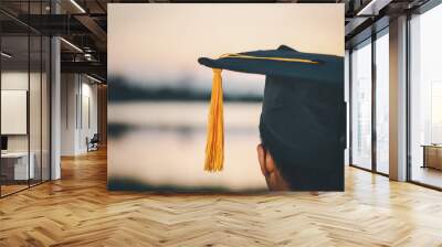 Graduates wear a black dress, black hat at the university level.. Wall mural