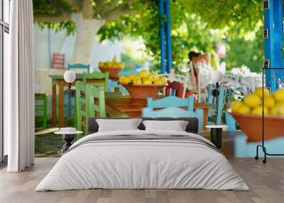 A dish of lemons in typical greek outdoor cafe Wall mural