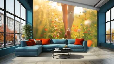 Back view of woman legs waking bare feet through flowering meadow. Sunny summer evening, enjoying nature. Wall mural