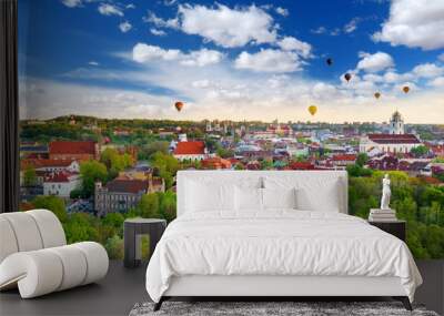 Beautiful summer panorama of Vilnius old town with colorful hot air balloons in the sky Wall mural