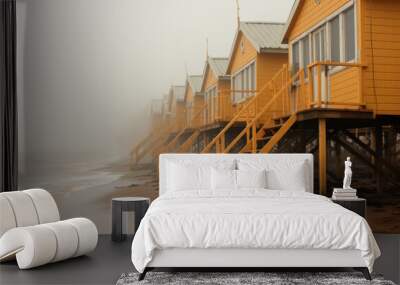 Beautiful wooden holiday houses on sand dunes of a Baltic sea landscape on foggy summer evening. Wall mural