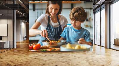 Cute ten years old boy helping his mother to cook food in kitchen. Mom and son preparing dinner at home. Mommy and child having quality time together. Bonding with preteen kids. Wall mural